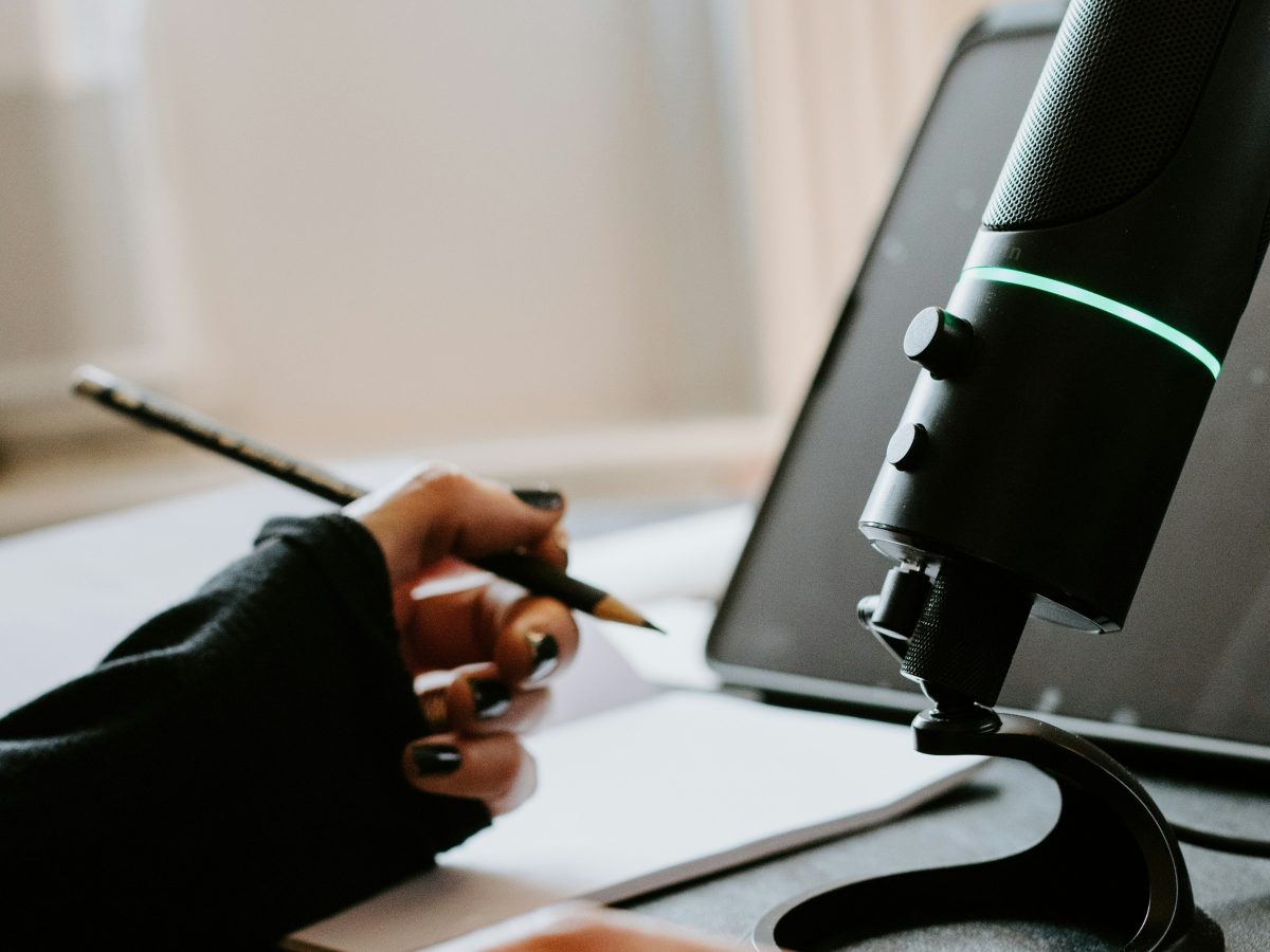 Close up shot of voice over artists work desk, recording equipment and laptop