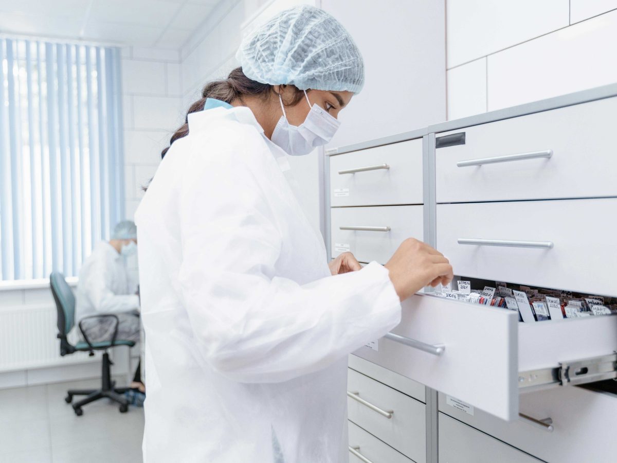 Medical professional opening a filing cabinet